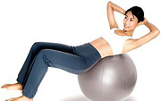 Woman does situps on excercise ball. - Copyright – Stock Photo / Register Mark