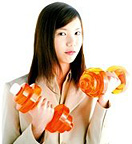A young woman holding dumbbell weights. - Copyright – Stock Photo / Register Mark