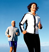 Older couple running on beach. - Copyright – Stock Photo / Register Mark